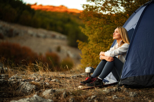 Woman enjoying peaceful camping trip in mountains