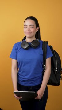 Young female student holding a tablet and smiling