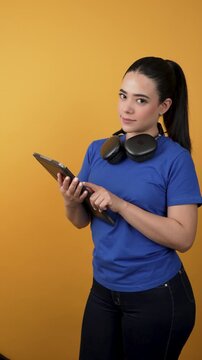 Young woman using digital tablet and headphones