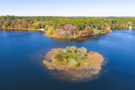 Colorful autumn foliage is found fringing Pilgrim Lake in Orleans, Massachusetts. This scenic destination is on the outer part of Cape Cod, not far from the Atlantic Ocean.