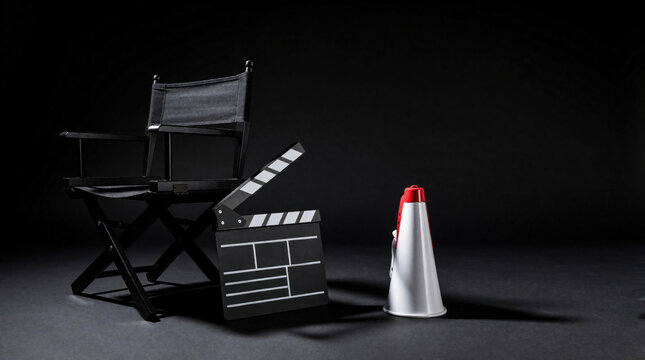 Black director chair with movie clapperboard, megaphone on dark background. Cinema equipment for film production set. Professional tools for filmmaker, producer, director in studio. Video industry