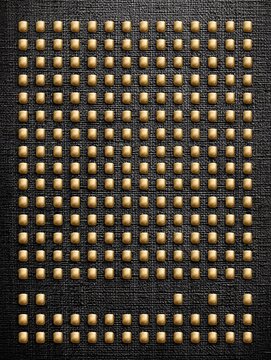Dark perforated panel with a neat grid of golden brass studs catching warm light, textured arena cladding backdrop for premium sport and event design