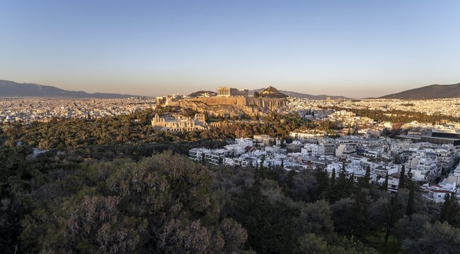 View from Philopappos Hill over the city at sunset, panorama of the Parthenon Temple and Herod's Amphitheatre, Acropolis, Athens, Greece