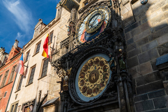 Prague, Czechia - 04 October 2026: View of the historic Prague Astronomical Clock on the Old Town Hall, featuring intricate zodiac dials and ornate statues under a clear blue sky.