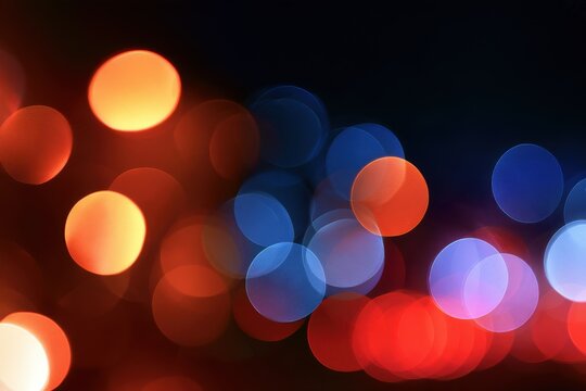 Red and blue bokeh lights mixing on dark background, contrasting warm and cool defocused circles for abstract festive celebration design concept art