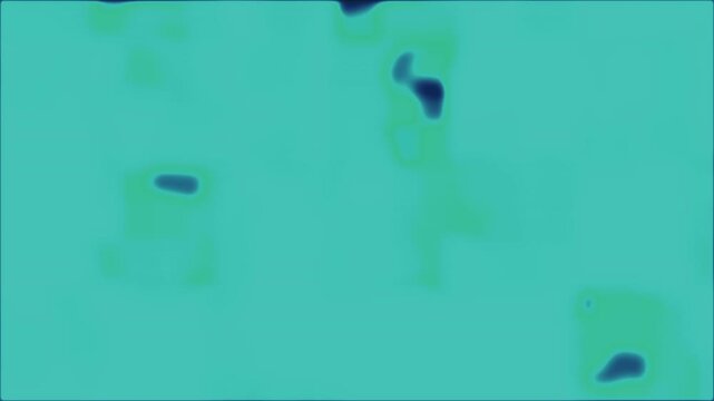 Paramecium swimming in turquoise liquid seen under microscope