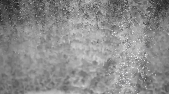 Slow motion close-up of crystal clear water flowing and creating powerful white foam splashing surface