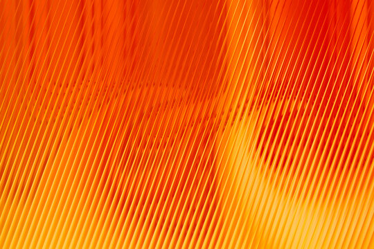 Abstract background with vibrant orange diagonal lines and soft light gradients creating a modern geometric texture