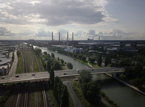 Overhead view of Volkswagen Factory and Mittellandkanal industrial zone with canal, motorway bridges and chimneys, Wolfsburg, Lower Saxony, Germany