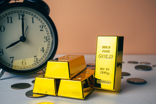 Gold bars with an alarm clock, time and gold investment, long-term wealth, patience, time management, and financial security concept