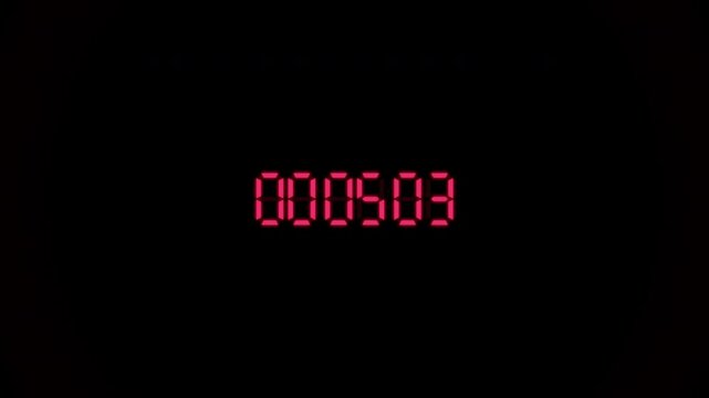 Multiple red digital led counters tick rapidly against a dark black background. six precision timers display glowing red numbers in a grid layout.