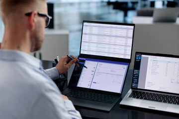 Fototapeta na wymiar Accountant Carefully Checks Electronic Invoices