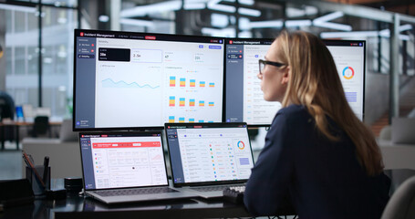 IT Incident Manager Monitoring Real-Time Alerts On Laptop