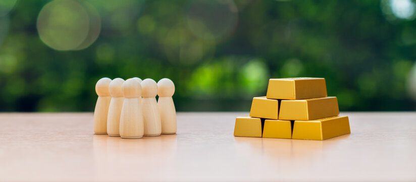 Wooden figure standing and stack of gold bars representing wealth and retirement planning