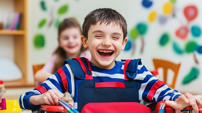 Boy laughing happily in a colorful classroom environment with his friend sitting blurred in the background