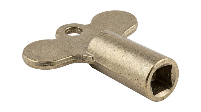 Metal clock wind-up key with brass finish on white background