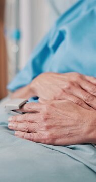Hands, person and bed in hospital with oximeter, monitor pulse and medical recovery of appendicitis. Mature woman, rest and SpO2 in icu ward for observation, oxygen levels and appendectomy treatment
