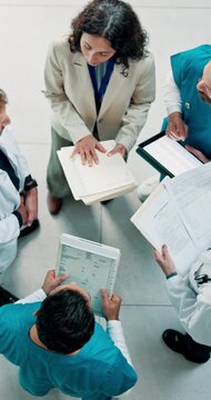 Above, doctor and medical team in hospital with documents, schedule management and research together. Healthcare manager, people and conversation in clinic with paperwork, agenda and brainstorming.