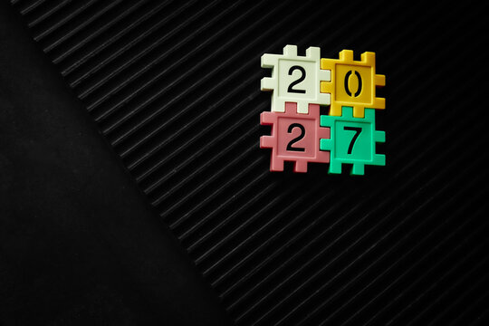 colorful puzzle blocks forming the number 2027
