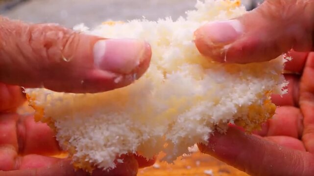 Hands stretching soft bread crumb