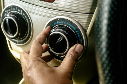 turning the air conditioner control knob on a car