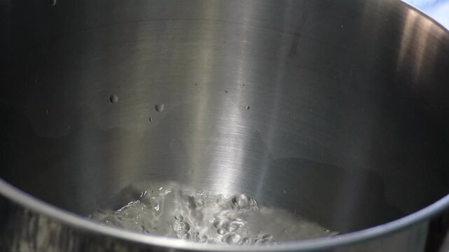 Preparing a saffron mixture in a steel pot for Moroccan rfissa