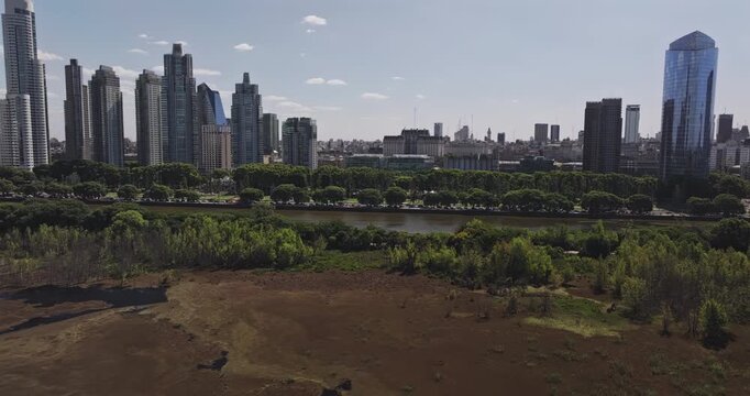 Buenos Aires Argentina Aerial v60 wide high angle tracking flyover across Costanera Sur wetlands toward the Puerto Madero and downtown skyline - Shot with 5k Camera - Jan 3rd 2026