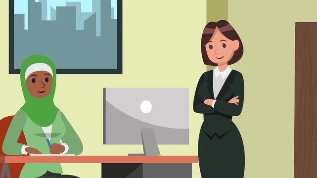 Muslim business woman wearing green hijab writing notes at office desk while colleague stands nearby watching