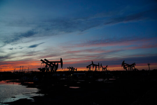 The oil pump, industrial equipment. Oil field site, oil pumps are running.