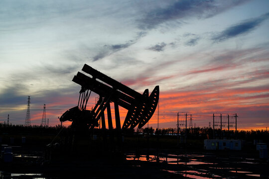 The oil pump, industrial equipment. Oil field site, oil pumps are running.