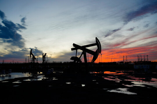 The oil pump, industrial equipment. Oil field site, oil pumps are running.