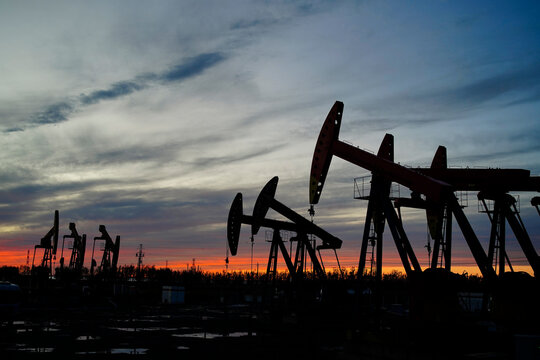 The oil pump, industrial equipment. Oil field site, oil pumps are running.