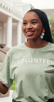 Volunteering, discussion or director outdoor with tablet, task brief or schedule in charity project. Happy, black woman or NGO lead with tech, coordination or appointing duty in outreach program.