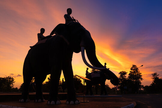The silhouette of an elephant monument in Surin province during a beautiful sunrise.