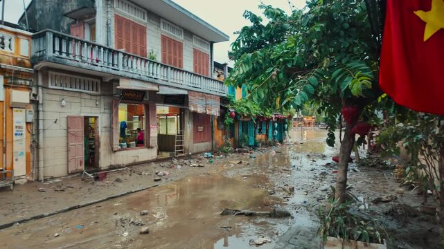 flooded city or town with buildings submerged in overflow water and mud, village underwater after heavy tropical rain and typhoon, consequences with dirt on the street 4k