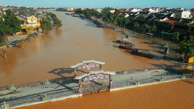 flooded city or town with buildings submerged in water, underwater village after heavy tropical rain and typhoon, An Hoi lantern bridge in Vietnam, climate change and global warming impact 4k