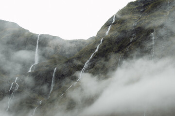 Long cascades behind mountain cloud in Norway during autumn travel © Olya