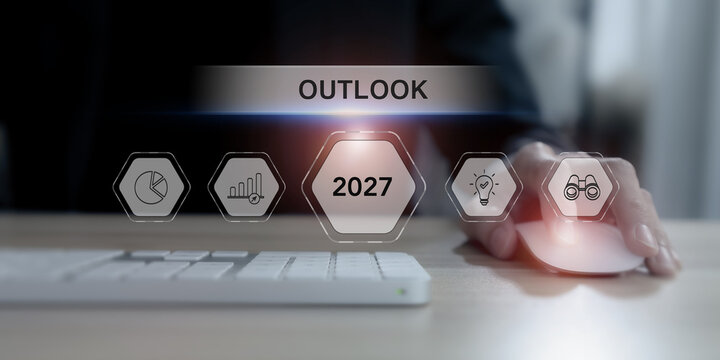 2027 Business Outlook. Future Forecast, Market Trends, Strategic Planning. Using a computer mouse with futuristic 2027 Outlook interface, with growth indicators, innovation, market forecasting icons.