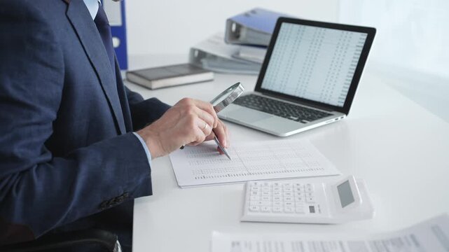 Professional auditor analyzing financial data, scrutinizing numbers and documents with a magnifying glass, performing detailed accounting and business analytics in an office setting