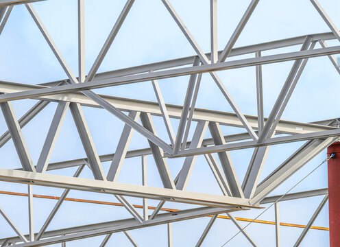 Close view of steel trusses on construction site.