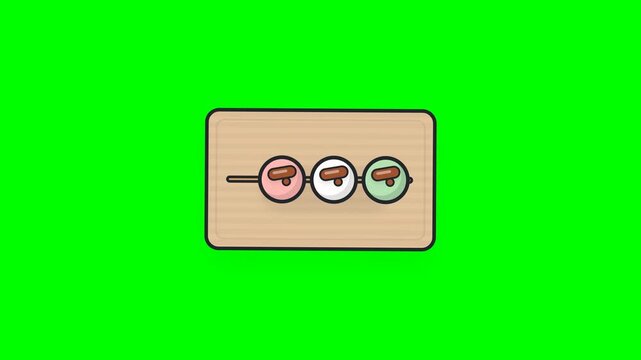 Japanese dango dumplings on wooden board over green background