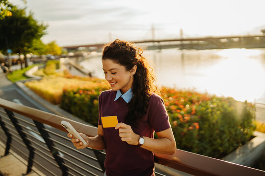 Woman making online payment with smartphone and credit card