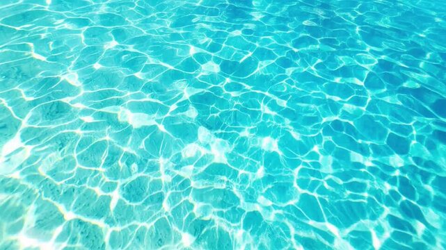 Bright sun reflections on turquoise sea surface with caustics ripples and glares in summer