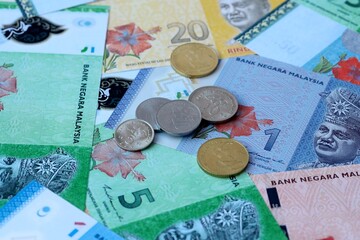 Malaysian ringgit money banknotes and coins on table. Malaysia cash bills of MYR currency © Viktor