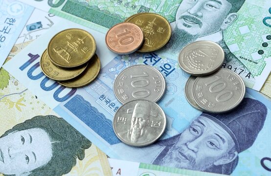 South Korean won money banknotes and coins on table. South Korea cash bills of KRW currency