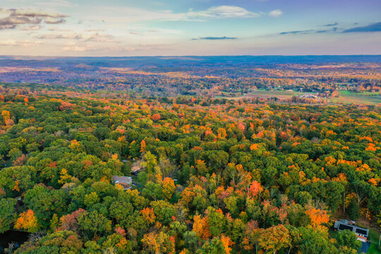 Hampton Township, Sussex County, NJ, surrounded by brilliant fall foliage at dusk aerial drone