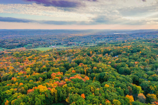 Hampton Township, Sussex County, NJ, surrounded by brilliant fall foliage at dusk aerial drone