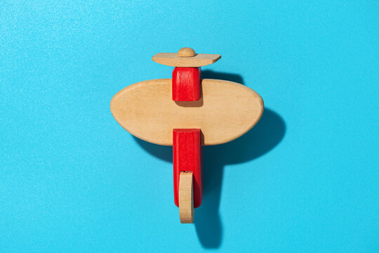 Wood airplane on blue background, top view