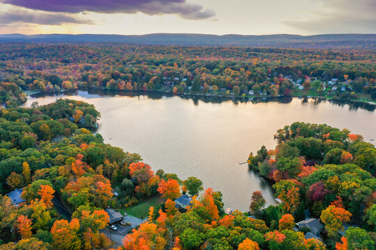 Kemah Lake in Hampton Township, Sussex County, NJ, surrounded by brilliant fall foliage at dusk aerial drone