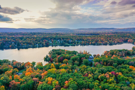 Kemah Lake in Hampton Township, Sussex County, NJ, surrounded by brilliant fall foliage at dusk aerial drone